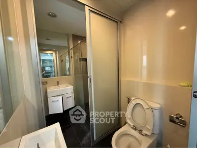 Modern bathroom with sleek fixtures and glass shower enclosure