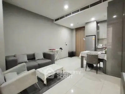 Modern open-plan living room with sleek kitchen and dining area