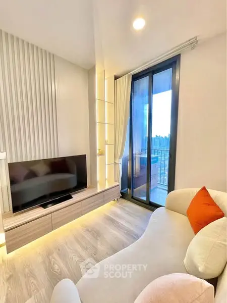 Modern living room with sleek TV unit and balcony view