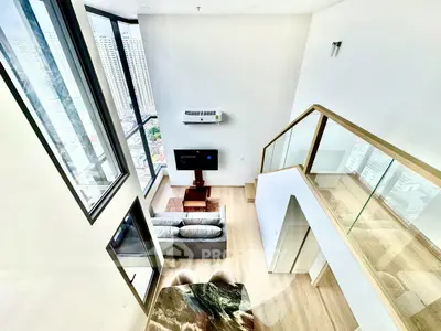 Stunning modern living room with high ceilings and city view from upper level