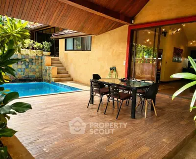 Charming outdoor patio with pool and dining area in a modern home