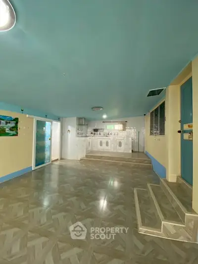 Spacious open-plan kitchen with tiled flooring and modern appliances