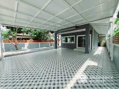 Spacious covered parking area with modern design and patterned flooring