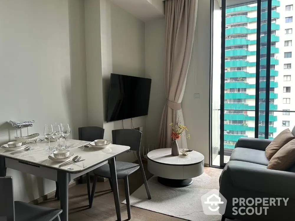 Modern living room with dining area and large window view in urban apartment