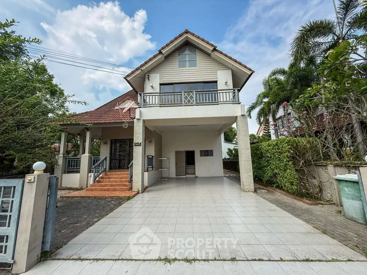 Charming two-story house with spacious driveway and lush greenery, perfect for family living.