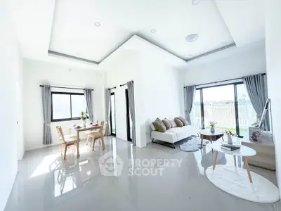 Spacious modern living room with elegant decor and abundant natural light.