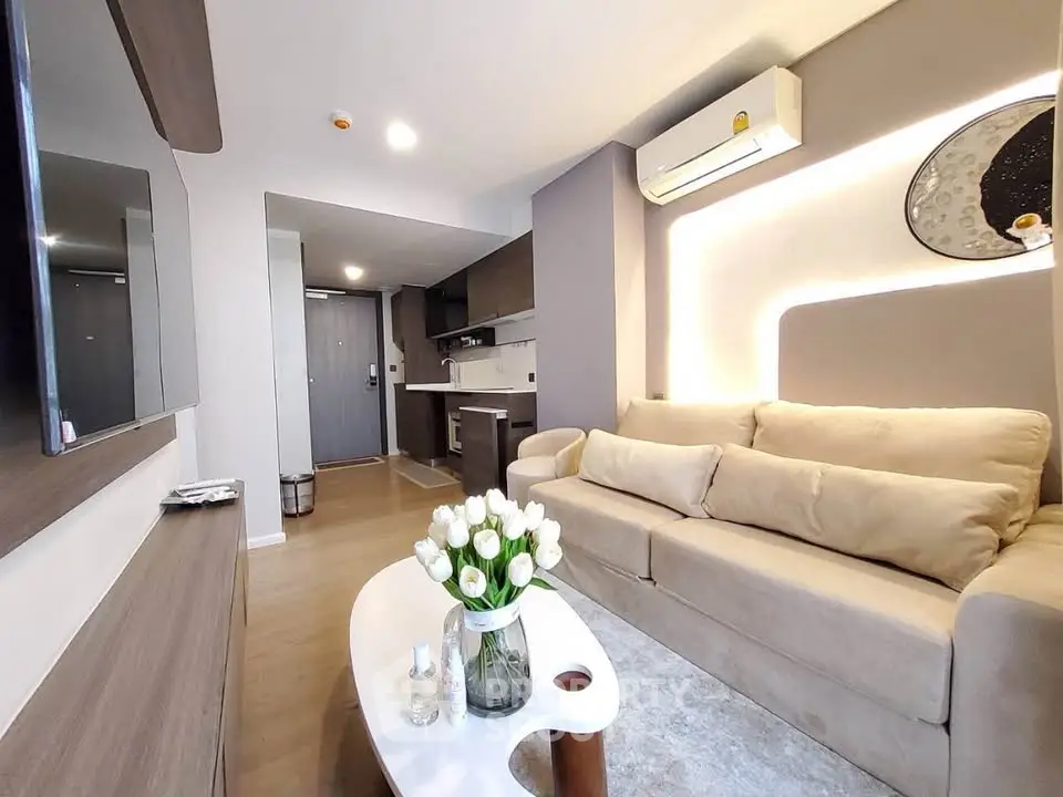 Modern living room with cozy beige sofa and stylish decor in a contemporary apartment.
