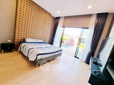 Spacious bedroom with modern decor and pool view, featuring large windows and stylish furnishings.