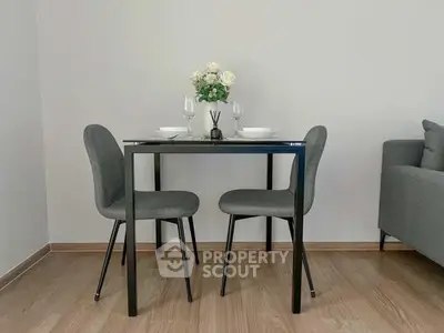 Modern dining area with sleek table and chairs in a cozy living space