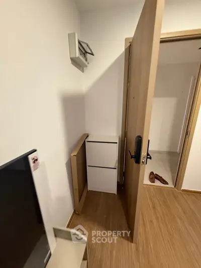 Compact entryway with wooden flooring and modern door design