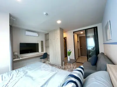 Modern bedroom with stylish decor, featuring a cozy bed, sleek furniture, and a wall-mounted TV for ultimate comfort.