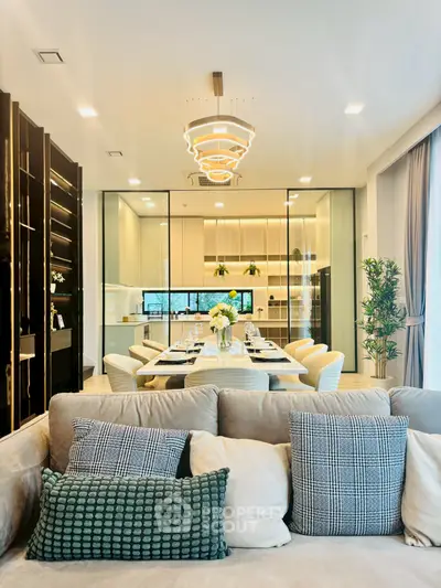 Luxurious open-plan living and dining area with modern kitchen and elegant decor.
