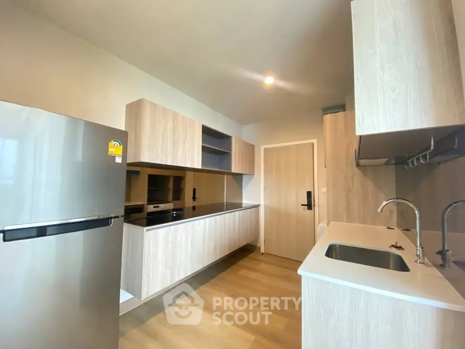 Modern kitchen with sleek wooden cabinets and stainless steel appliances