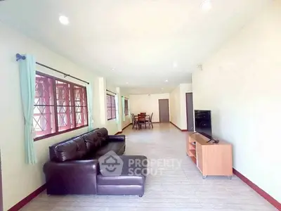 Spacious living room with modern furniture and large windows for natural light
