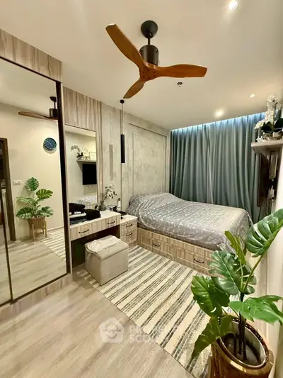 Modern bedroom with stylish decor and ceiling fan, featuring a cozy bed and elegant furnishings.