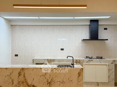 Luxurious modern kitchen with marble countertops and sleek gas stove