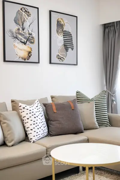 Chic modern living room with stylish sofa adorned with trendy cushions, complemented by elegant art pieces and a sleek coffee table.