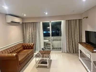 Stylish living room with leather sofa and balcony access in modern apartment.