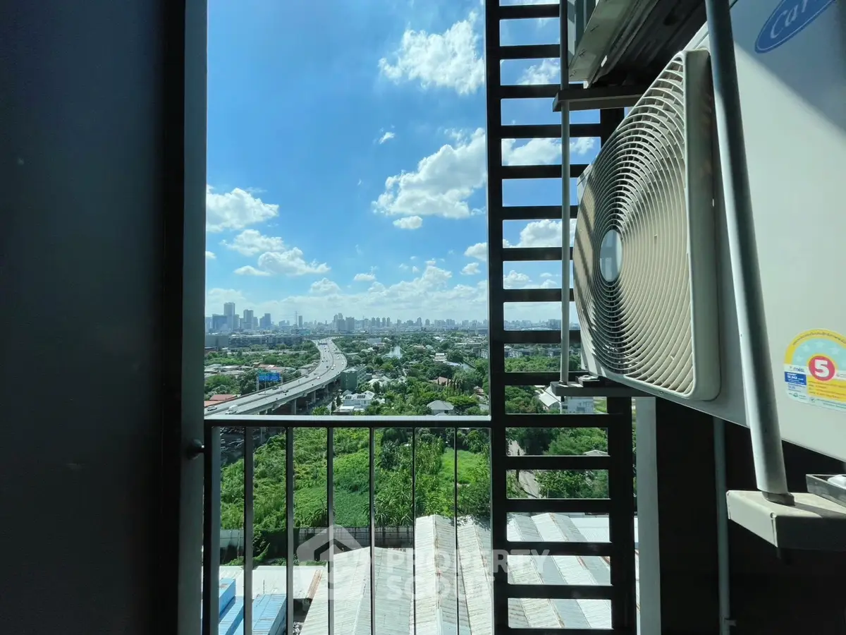 Stunning cityscape view from a high-rise balcony with air conditioning unit.