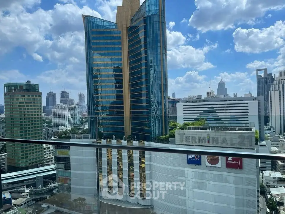 Stunning cityscape view from a high-rise balcony overlooking modern skyscrapers and urban skyline.
