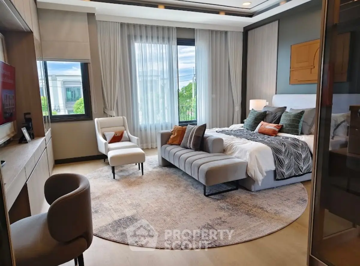 Luxurious modern bedroom with elegant decor and large windows offering natural light.