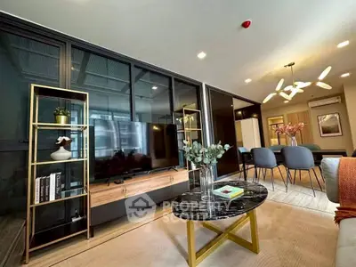 Modern living room with stylish decor and open dining area