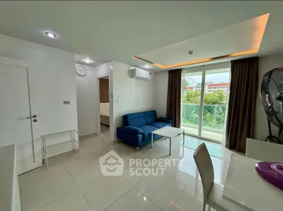 Modern living room with blue sofa, large window, and sleek white flooring.