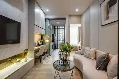 Modern living room with stylish decor and open layout, featuring a cozy seating area and workspace.