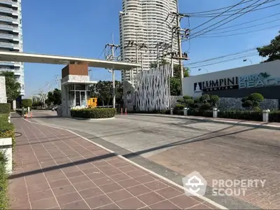 Luxurious condominium entrance with modern design and lush landscaping