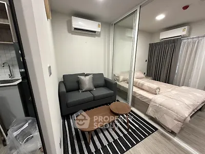 Modern studio apartment with cozy living area and bedroom, featuring air conditioning and stylish decor.