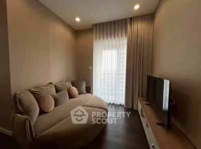 Cozy living room with modern sofa and TV, perfect for relaxation.