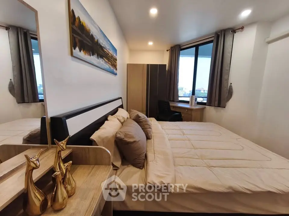 Cozy bedroom with modern decor and large window view