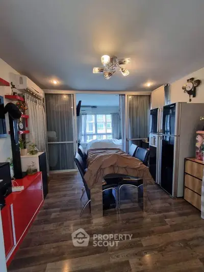 Modern studio apartment with stylish decor and open layout, featuring sleek flooring and contemporary lighting.