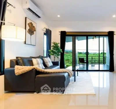 Spacious living room with modern decor and large balcony offering stunning views.