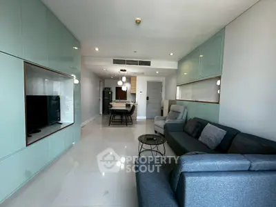 Modern living room with sleek furniture and open layout, featuring a stylish dining area and contemporary decor.