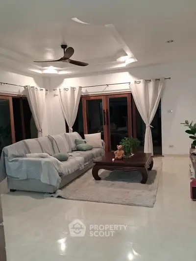 Spacious living room with elegant decor and large windows for natural light.