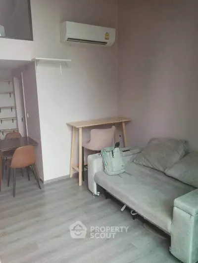 Modern living room with sleek furniture and air conditioning in a stylish apartment.