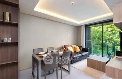 Modern living room with dining area and balcony view, featuring stylish furniture and ambient lighting.
