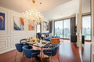 Luxurious living room with chandelier and city view in high-rise apartment.