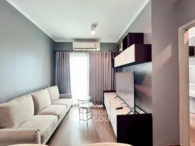 Modern living room with sleek furniture and natural light, perfect for relaxation and entertainment.