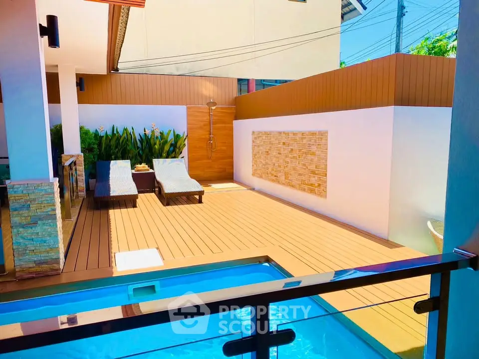 Luxurious private pool area with sun loungers and modern design elements.