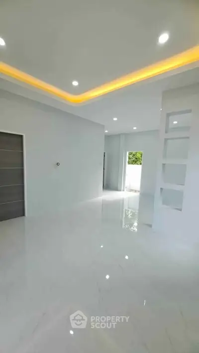 Spacious modern living room with glossy white floors and recessed lighting