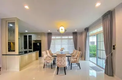 Spacious open-plan dining area with elegant decor and large windows for natural light.