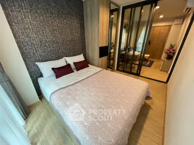 Cozy modern bedroom with stylish decor and mirrored wardrobe in a contemporary apartment.
