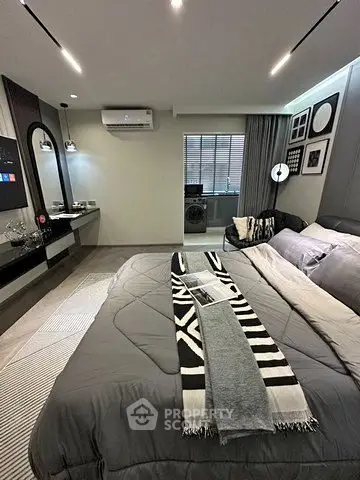 Modern bedroom with stylish decor and cozy ambiance, featuring a comfortable bed and elegant furnishings.