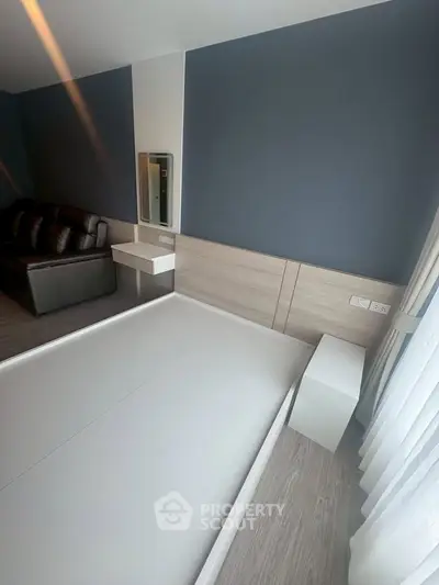 Modern bedroom with sleek design and stylish furniture, featuring a large bed and elegant decor.