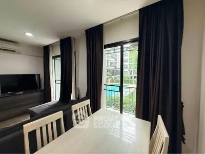 Modern living room with pool view, featuring sleek furniture and large windows for natural light.
