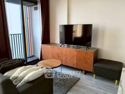 Modern living room with sleek TV stand and balcony view