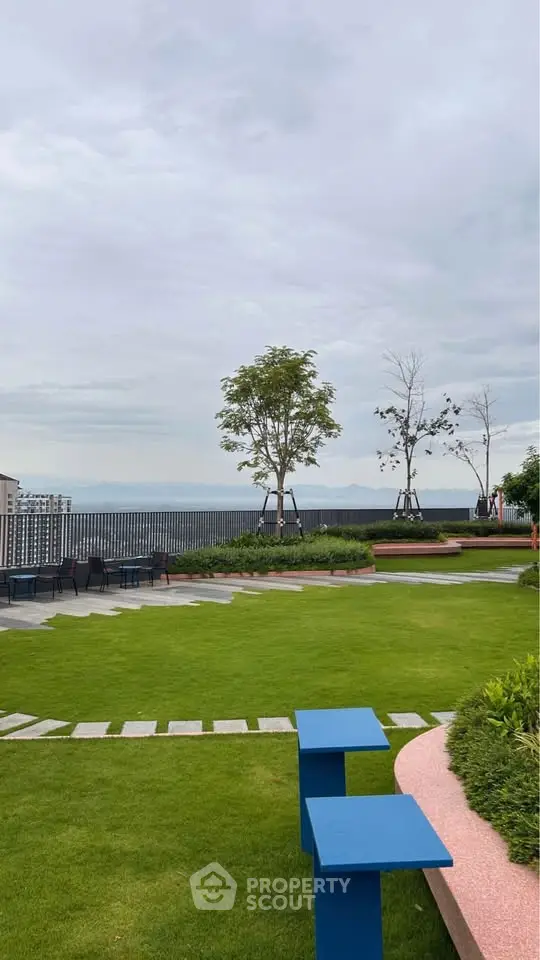 Stunning rooftop garden with ocean view and modern seating area.