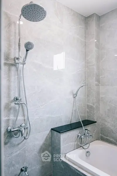 Modern bathroom with elegant marble tiles and sleek shower design.